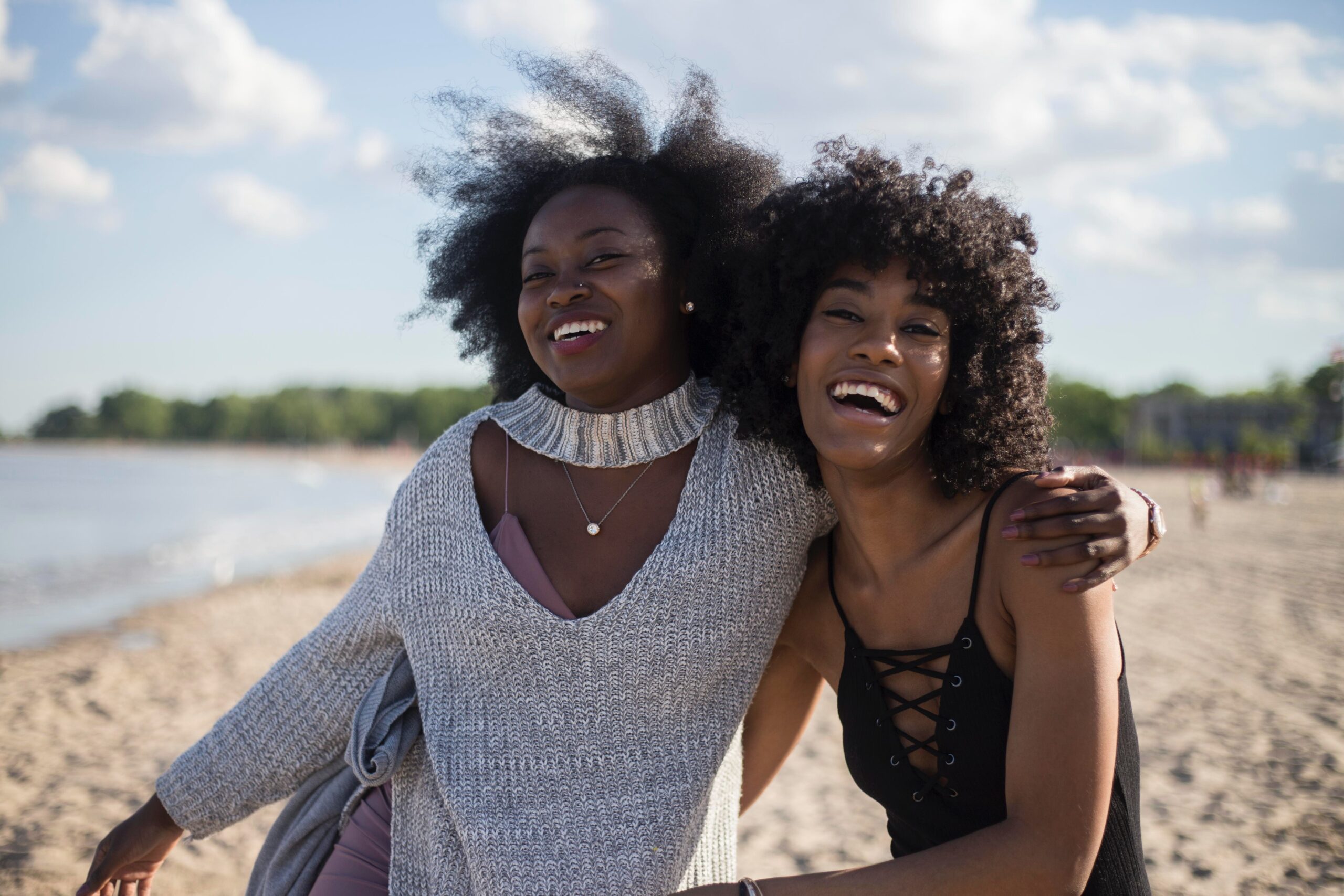 two black women with big afro hair laughing