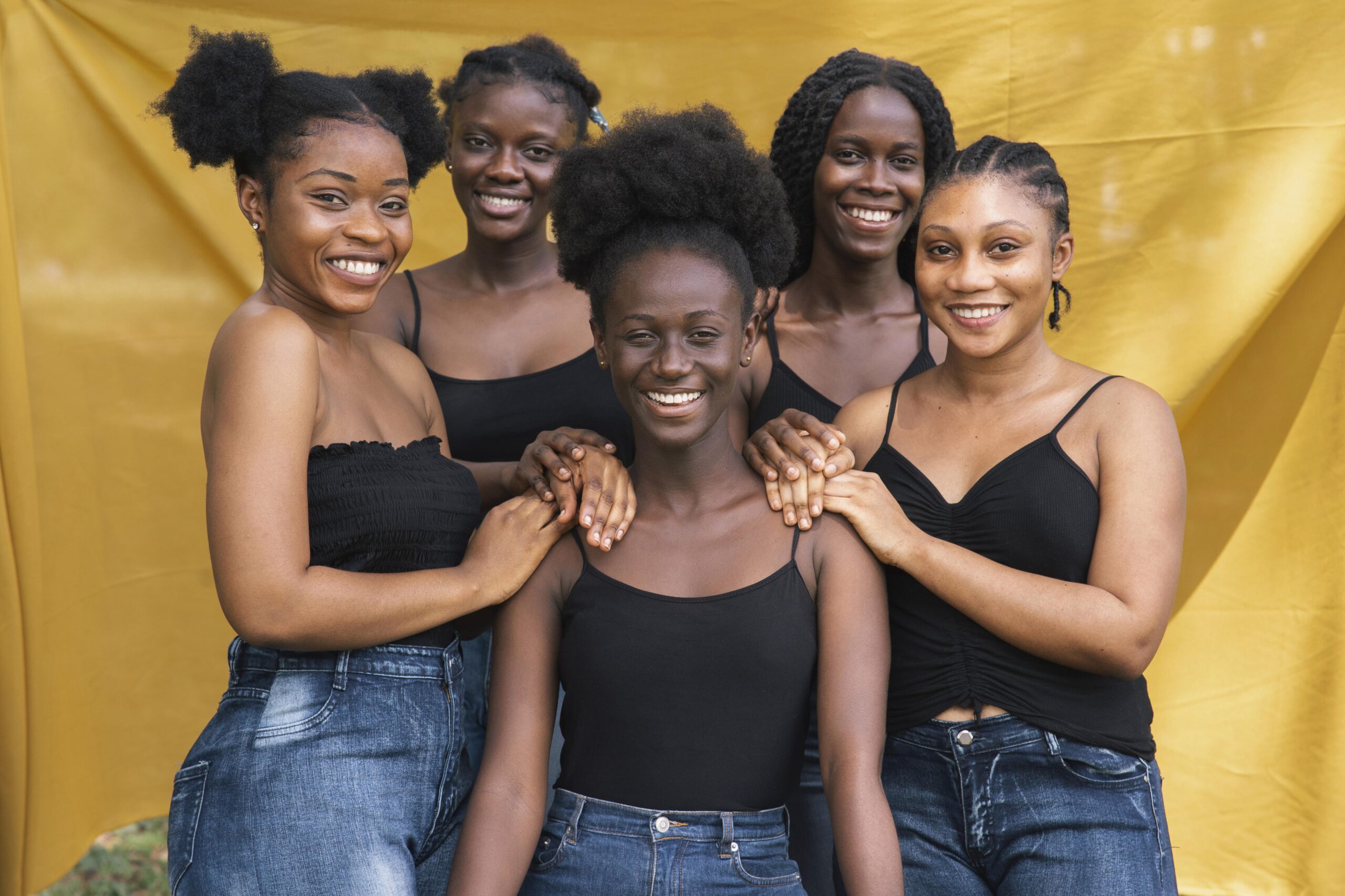 Five black women with afro hair posing together